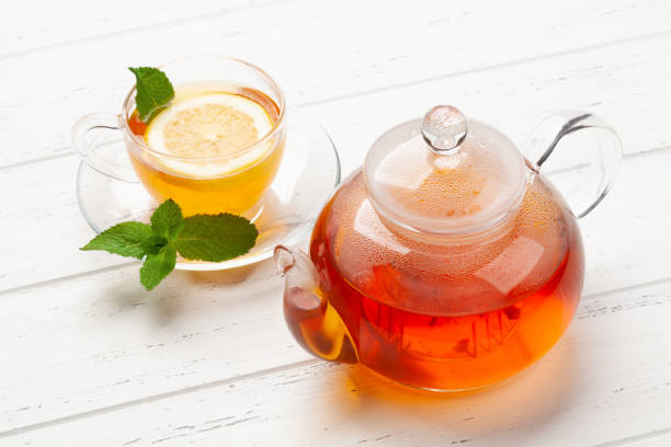 istock Herbal tea with mint and lemon. Tea cup and teapot 1309697790