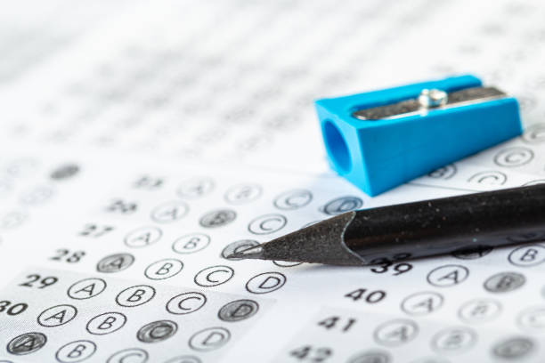 istock testing in exercise and exam paper. computer sheet with pencil in school test room, education concept. filling in answers in pencil 1309699353
