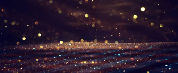 istock background of abstract gold and black glitter lights. defocused 1309699516