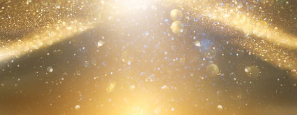 istock background of abstract gold and black glitter lights. defocused 1309699531