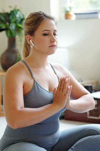 istock Woman enjoying meditation practice 1309699817