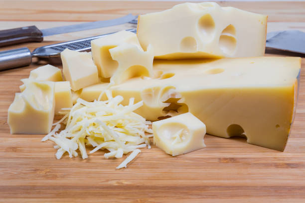 istock Partly sliced and grated semi-hard cheese on cutting board 1309700788