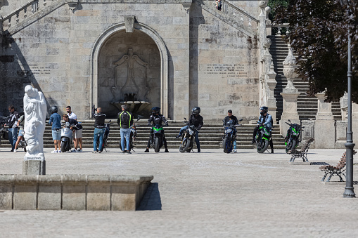 Lamego / Portugal - 07 25 2019 : View at the staircase entrance with a group of bikers and motorcycles, Lamego Cathedral with a huge stairway