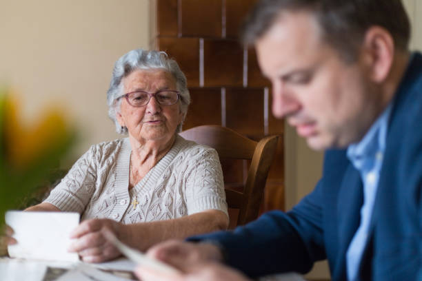 istock Senior woman sitting with her grandson and showing him documents 1309701962