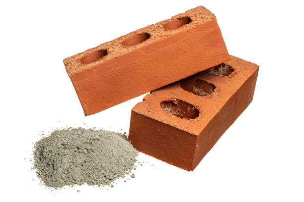 istock Two bricks and a heap of cement on white 1309703611