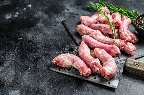istock Raw Turkey neck meat on a cutting board. Black background. Top view. Copy space 1309704582
