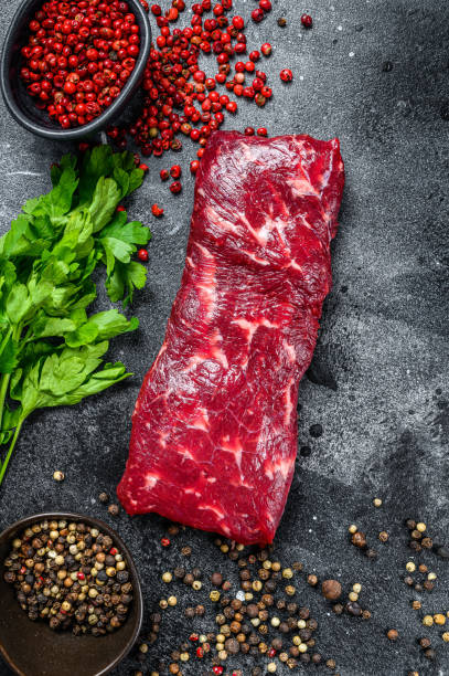 istock Raw marble beef meat steak. Black background. Top view 1309704878