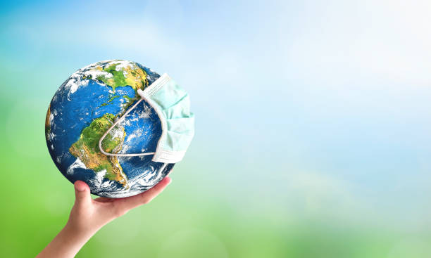 istock Earth day concept: human hand holding earth globe over blurred green and blue nature background. Elements of this image furnished by NASA 1309707242