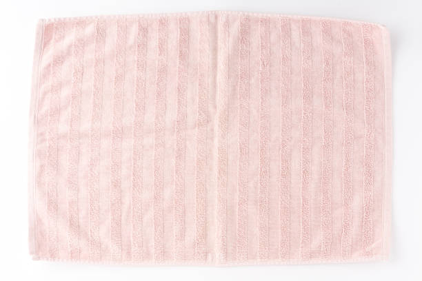 istock Pink beach towel isolated on white background. Top view 1309707700