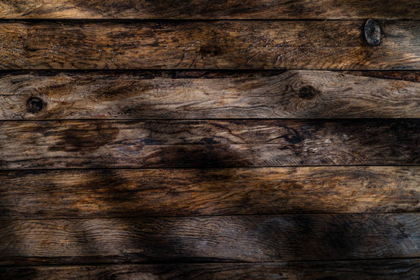 istock Old dark weathered wood plank background 1309707718