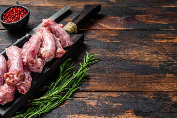 istock Chicken neck meat on a cutting board. Wooden background. Top view. Copy space 1309708849