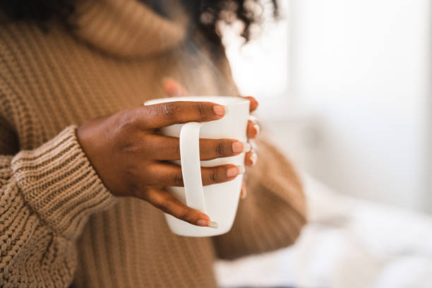 University student with hot coffee at home