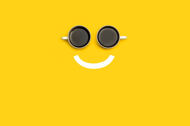 Smiling face made with two cups of coffee Smiling face made with two cups of coffee on a yellow background anthropomorphic smiley face photos stock pictures, royalty-free photos & images