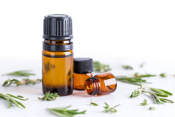 istock Rosemary and thyme sprigs with dark glass jar. 1309711504