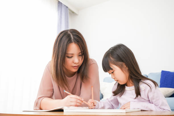 istock A little girl studying with her mother 1309712581