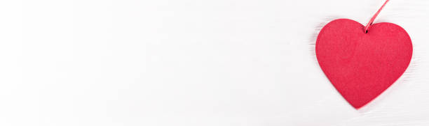 istock Heart on white wooden table. Long banner 1309712865