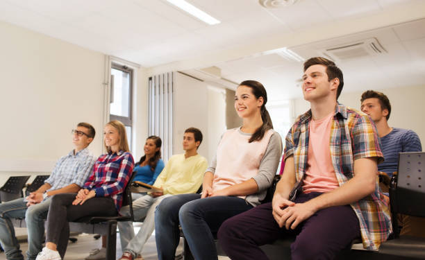 istock group of smiling students in lecture hall 1309713944