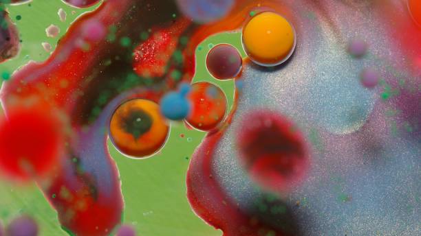 istock Bubbles float in liquid paint, mixing ink, oil and milk, abstract multicolor hypnotic painting 1309714268