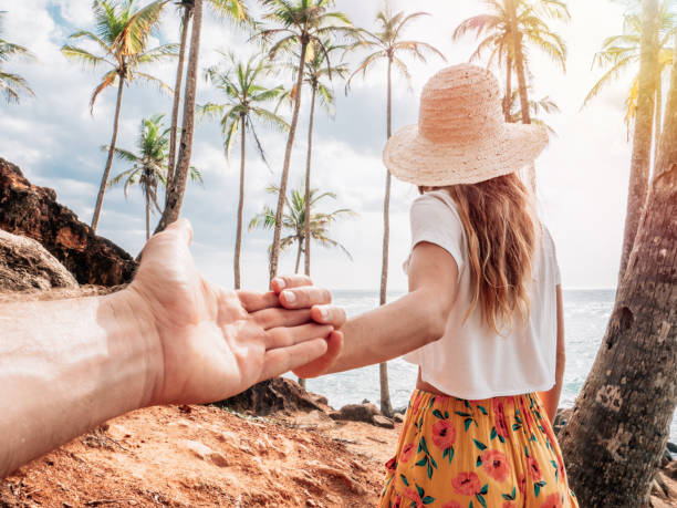 istock Couple holding hands on mountain palm tree hill 1309714946