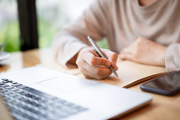 istock Woman working at co-working space in coffee shop 1309715309