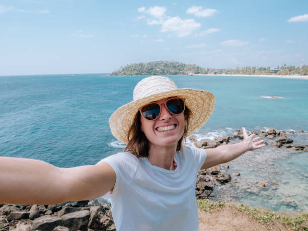 istock Woman takes selfie with seascape 1309715664