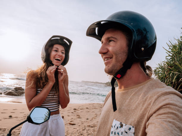istock Couple on scooter stops at the beach for sunset 1309716006