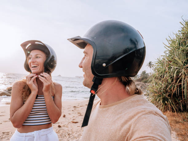 istock Couple on scooter stops at the beach for sunset 1309716450