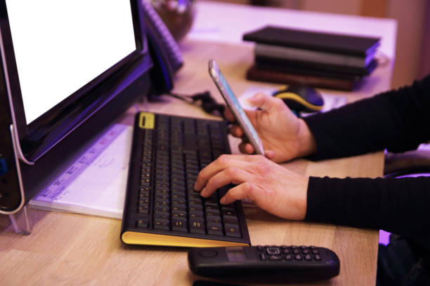 istock Businesswoman using a mobile phone and a laptop while working. 1309716518