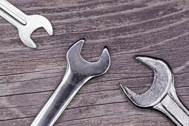istock wrenches on a wooden background 1309717369