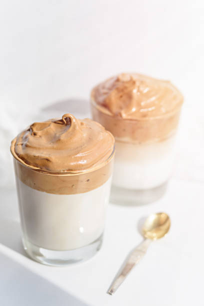 istock dalgona coffee in glasses with dessert spoon on white background in morning light 1309717551