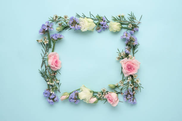 istock flower frame on blue background, composition of roses, limonium, eustoma, top view, flat lay, copy space 1309717873
