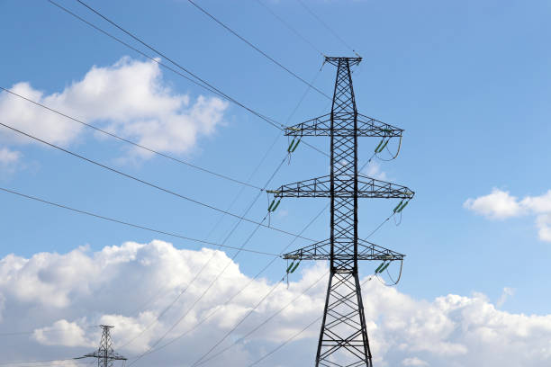 istock High voltage towers with electrical wires on blue sky with white clouds 1309718511
