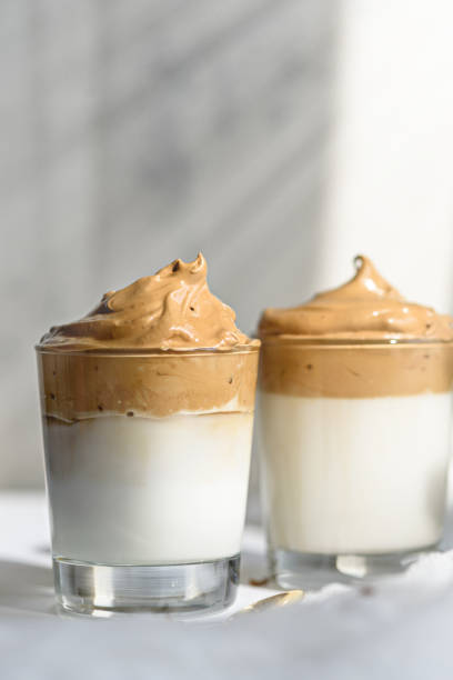 istock vertical trendy dalgona coffee with foam in glasses on white background, korean coffee concept 1309718881