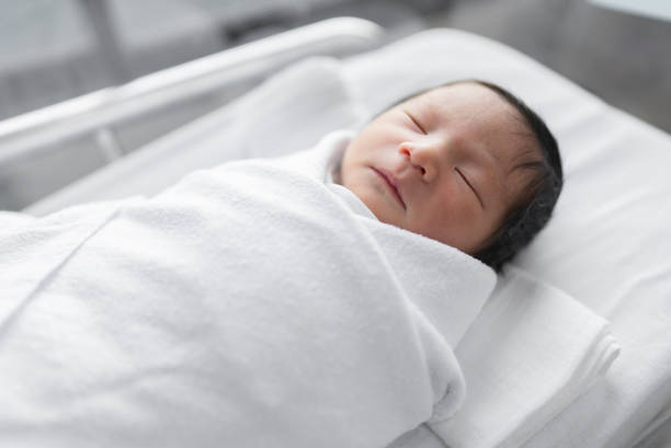 istock Newborn baby sleeping in hospital. 1309718906