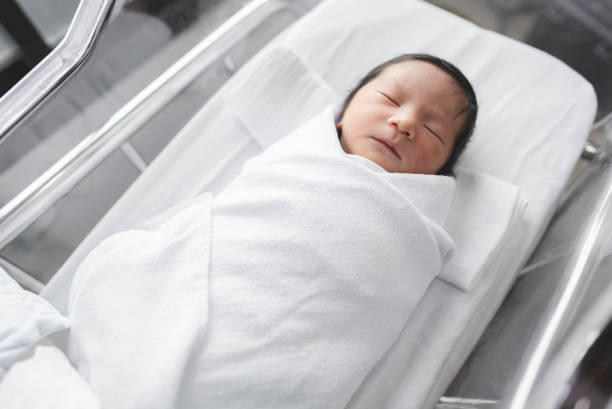 istock Newborn baby sleeping in hospital. 1309718908