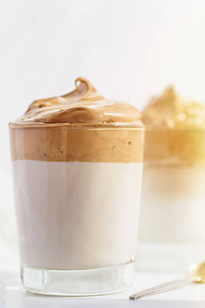 istock vertical dalgona coffee with whipped foam in glasses on white background morning light, korean coffee concept 1309720019