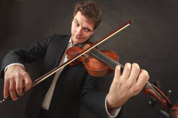 istock Man playing violin showing emotions and expressions 1309720099