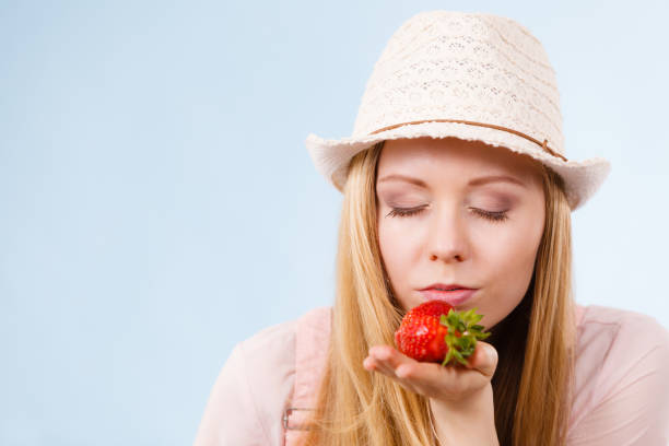 istock Happy woman holding strawberries 1309720774