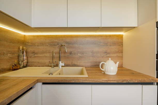 istock Modern white and beige wooden kitchen interior details 1309720886