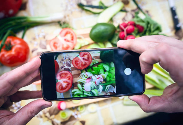 istock Man taking a photograph of vegetables on table 1309721888