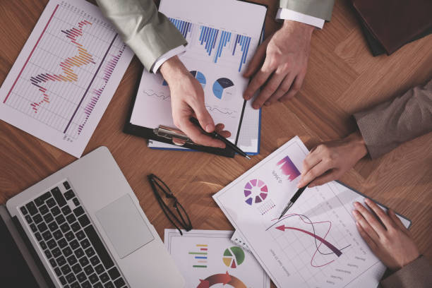 istock Business people working with charts and graphs at table, top view. Investment analysis 1309723635