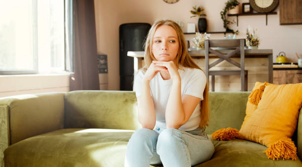 Boring and sad. Young woman worried, having psychological problem, feeling depression symptoms. Boring and sad. Young woman worried, having psychological problem, feeling depression symptoms. Upset frustrated lonely female thinking of  trouble. wasting time photos stock pictures, royalty-free photos & images