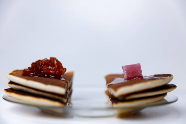 Pancakes with apple jam and Turkish delight on a plate.