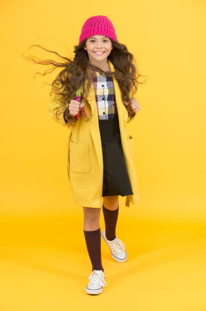 istock happy pupil kid yellow wall. back to school. desire for study. smiling child craving for education. retro and modern school. small girl enjoy autumn. stylish schoolgirl go forward. go to school 1309727507