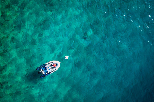 istock Top view of  turquoise water and boat. 1309729053