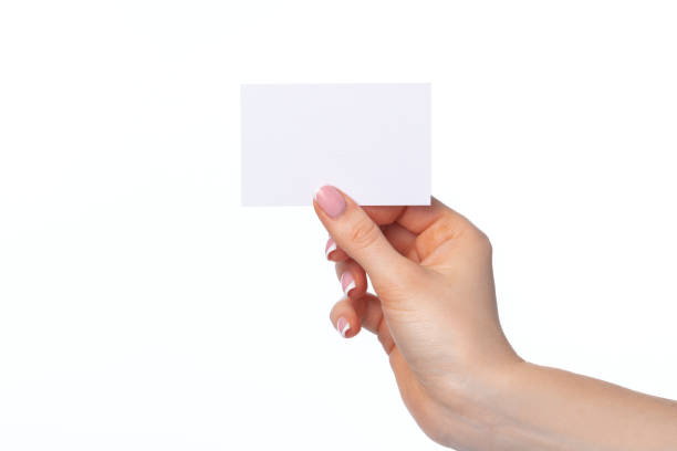 istock Female hand with blank white business card isolated on white 1309730028