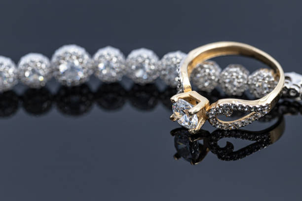 istock An elegant women's gold ring with a diamond is placed on a bracelet with precious stones 1309730046