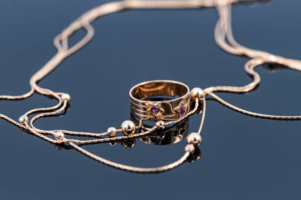 istock Wide gold ring and chain with large gold beads 1309730093