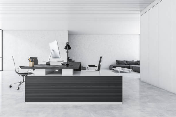 istock White and black office room with armchairs and table with computer 1309730453
