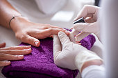 Woman having nails polished in the beauty salon